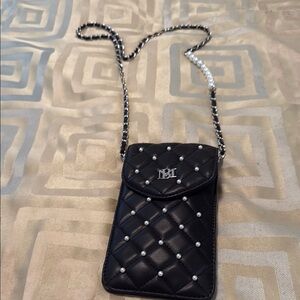 Crossbody bag black quilted with pearl accent.